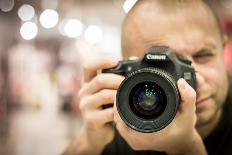 Mann macht ein Foto mit einer Kamera.